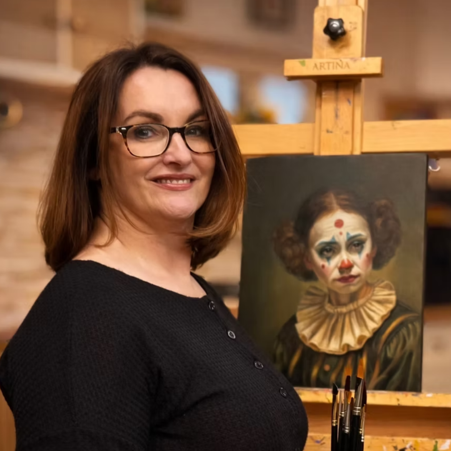 Marion Dutton in her studio beside a portrait painting